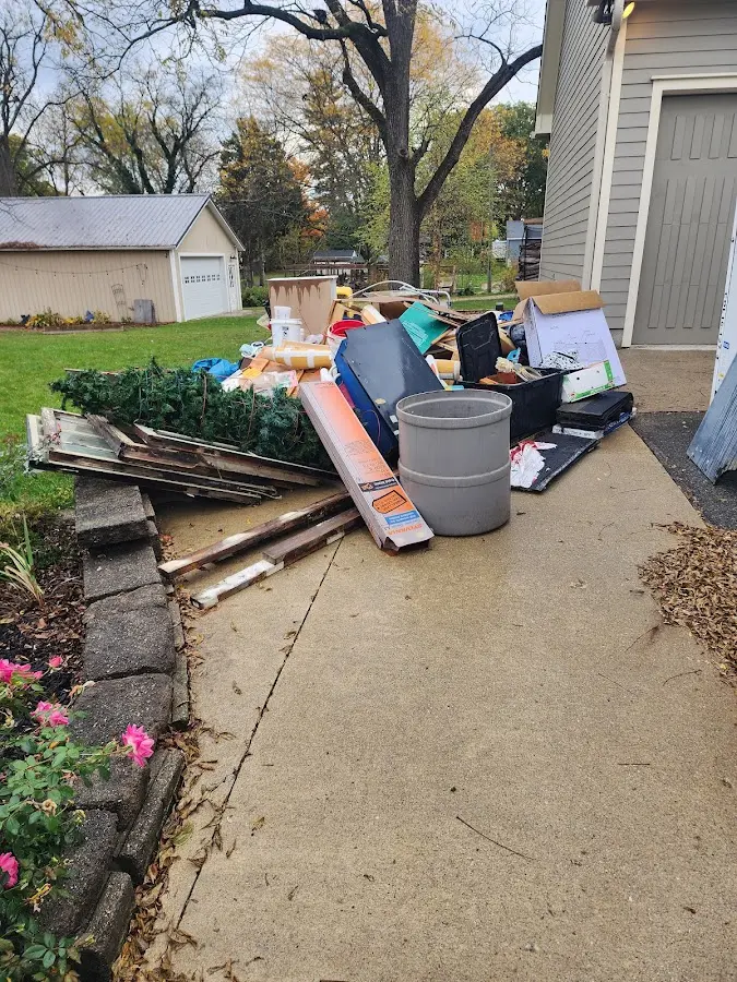 Dumpster being loaded with debris for Residential Dumpster Rental in Essex Junction